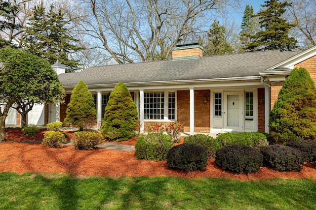 1060 Chestnut St, Ann Arbor, MI 48104 - ranch-style house featuring a front lawn, roof with shingles, a chimney, and brick siding