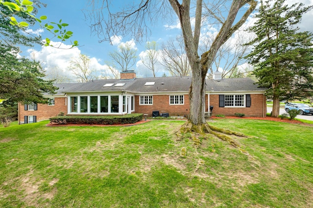 1060 Chestnut St, Ann Arbor, MI 48104 - back of house featuring a chimney, brick siding, and a lawn