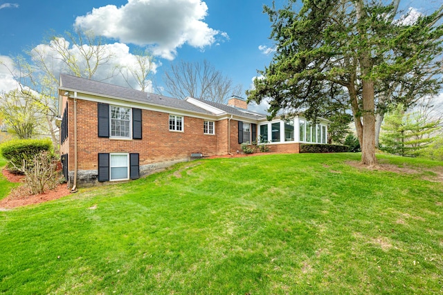 1060 Chestnut St, Ann Arbor, MI 48104 - rear view of house with a lawn, a chimney, and brick siding