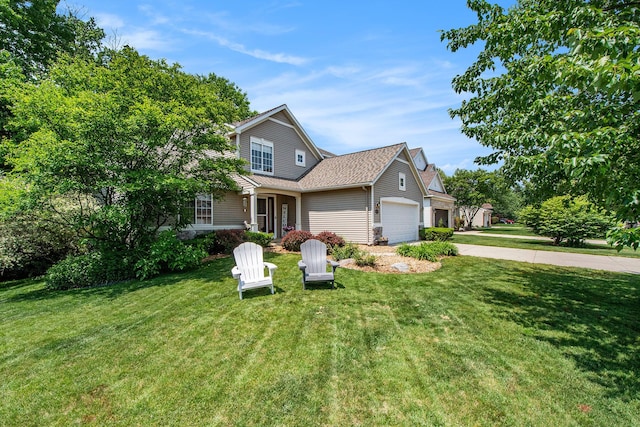 5591 E Grove Dr SE, Grand Rapids, MI 49512 - traditional home with a garage, a front yard, driveway, and a shingled roof