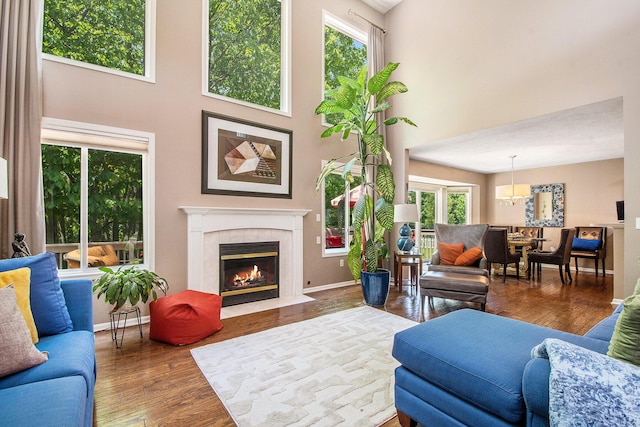 5591 E Grove Dr SE, Grand Rapids, MI 49512 - living area featuring a towering ceiling, wood finished floors, and a tile fireplace