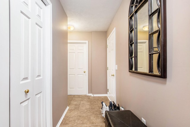 5591 E Grove Dr SE, Grand Rapids, MI 49512 - corridor featuring baseboards and tile patterned floors