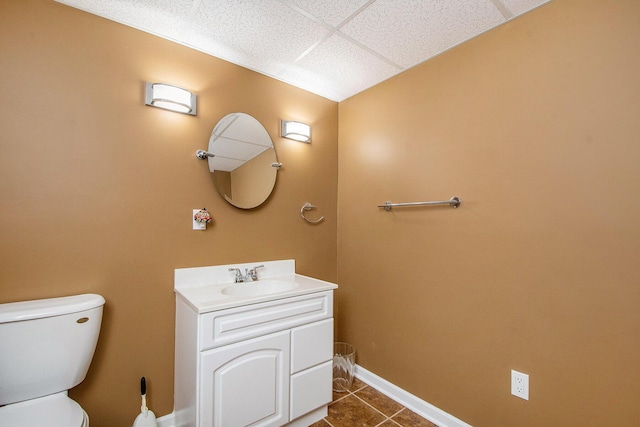5591 E Grove Dr SE, Grand Rapids, MI 49512 - half bathroom with tile patterned flooring, vanity, and a paneled ceiling