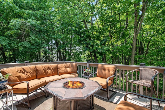 5591 E Grove Dr SE, Grand Rapids, MI 49512 - deck with an outdoor living space with a fire pit and view of wooded area