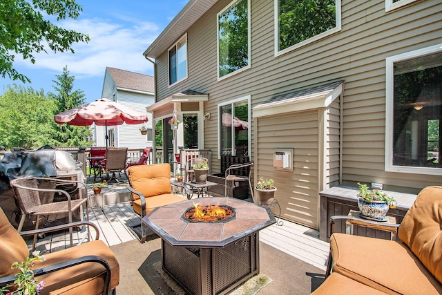 5591 E Grove Dr SE, Grand Rapids, MI 49512 - deck featuring a fire pit and outdoor dining area