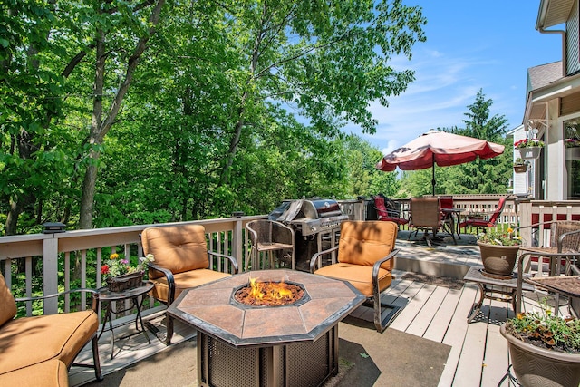 5591 E Grove Dr SE, Grand Rapids, MI 49512 - wooden deck featuring an outdoor fire pit, outdoor dining space, and grilling area