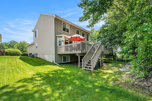 5591 E Grove Dr SE, Grand Rapids, MI 49512 - back of house featuring a deck, stairway, and a lawn