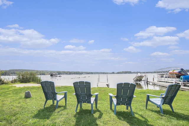 view of yard with a water view and a boat dock