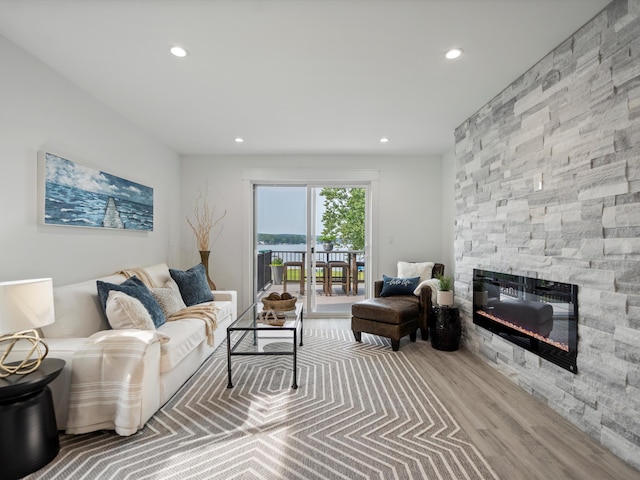 living area with a fireplace, wood finished floors, and recessed lighting