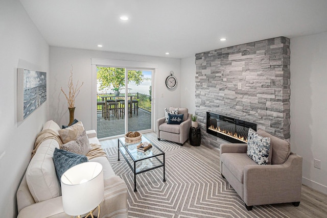 living room with baseboards, recessed lighting, wood finished floors, and a fireplace