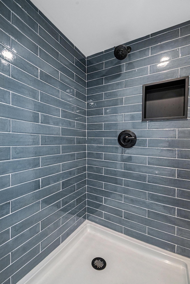 bathroom with a tile shower
