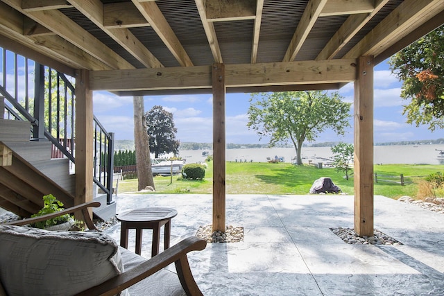 view of patio with stairway and a water view