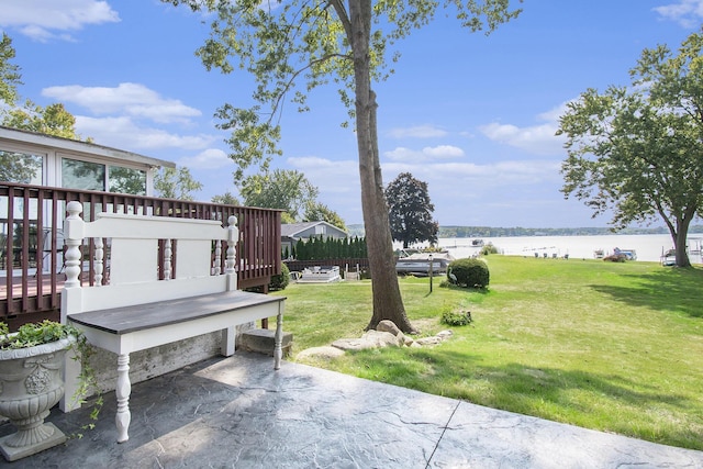 view of yard with a deck with water view