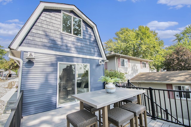 wooden terrace featuring outdoor dining area
