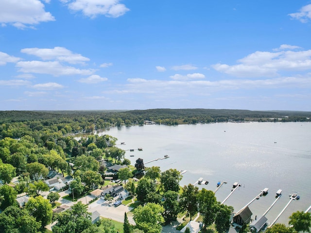 aerial view with a water view and a forest view