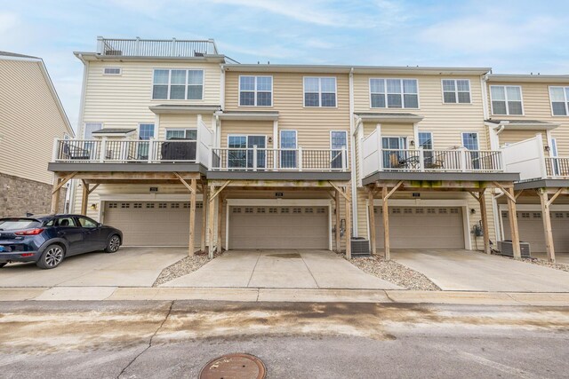 2715 S Spurway Dr, Ann Arbor, MI 48105 - view of property with an attached garage, driveway, and central AC