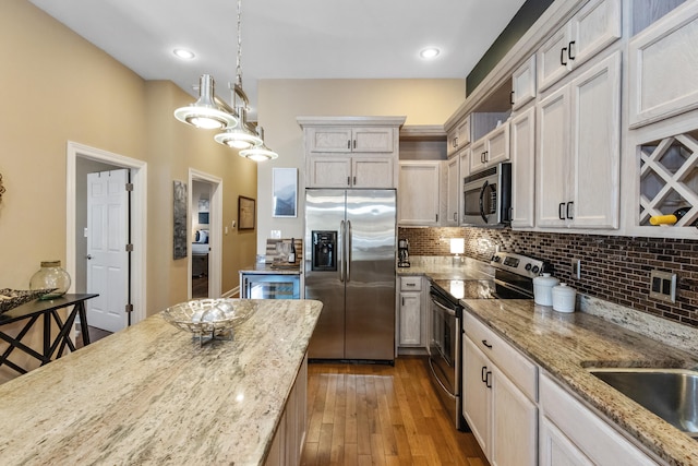 221 N Townsend St, New Buffalo, MI 49117 - kitchen with stainless steel appliances, open shelves, backsplash, and decorative light fixtures