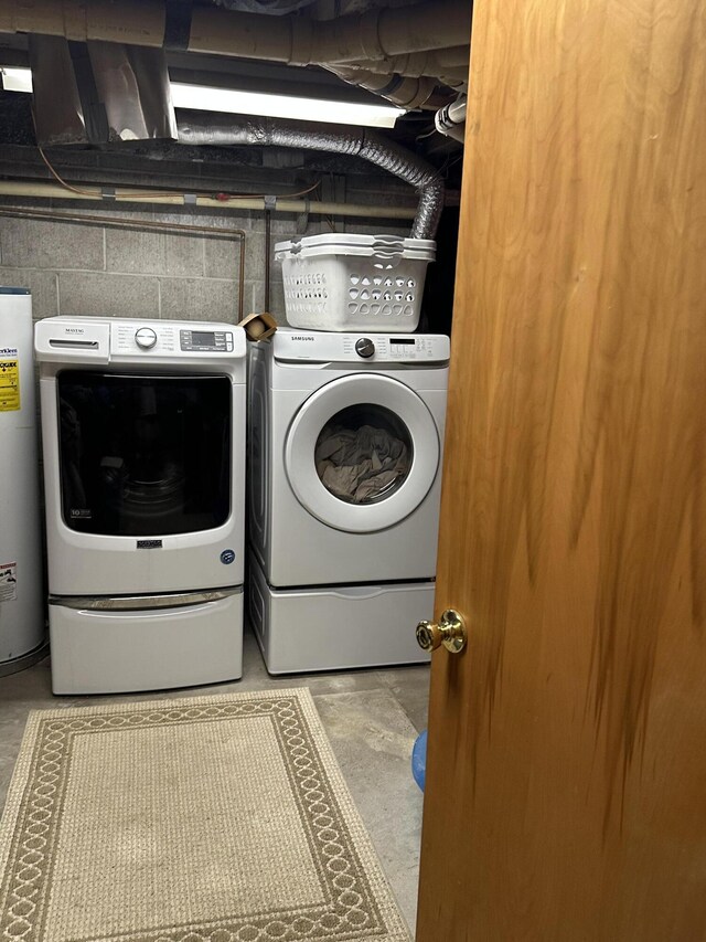 2080 N Mears St, Mears, MI 49436 - clothes washing area featuring concrete block wall, washing machine and dryer, water heater, and laundry area