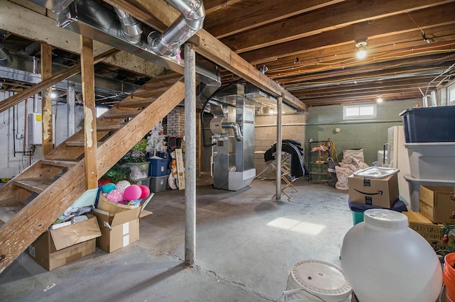 below grade area with water heater, stairway, and heating unit