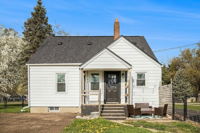 bungalow featuring fence, a shingled roof, and a chimney