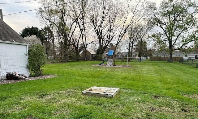 view of yard with fence and a playground