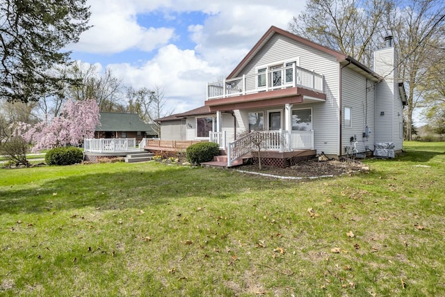150 Hyde Rd, Clarklake, MI 49234 - back of house with a balcony, a chimney, a yard, and a wooden deck