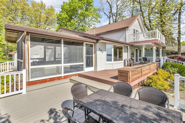 150 Hyde Rd, Clarklake, MI 49234 - wooden deck featuring outdoor dining area and a sunroom