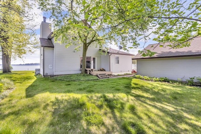 150 Hyde Rd, Clarklake, MI 49234 - back of property with a yard, a chimney, and a deck with water view