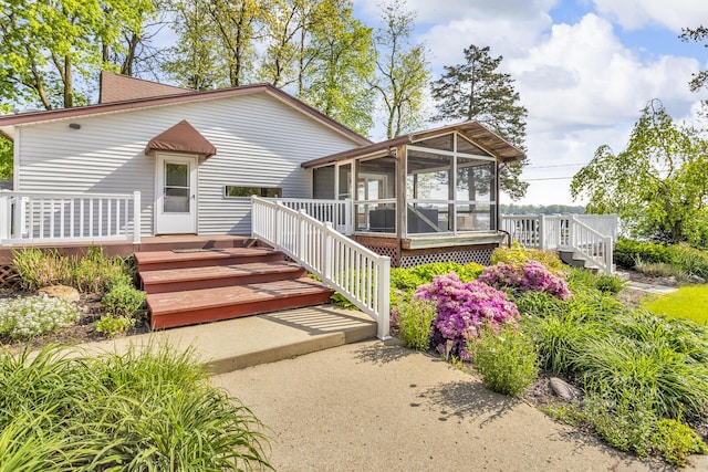 150 Hyde Rd, Clarklake, MI 49234 - view of front of house featuring a sunroom, a wooden deck, and stairway