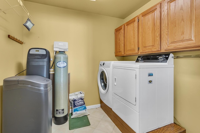 150 Hyde Rd, Clarklake, MI 49234 - washroom with washing machine and clothes dryer, cabinet space, light tile patterned flooring, and baseboards