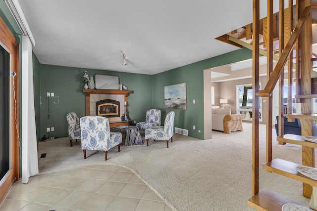 150 Hyde Rd, Clarklake, MI 49234 - living area featuring carpet, a glass covered fireplace, and tile patterned flooring