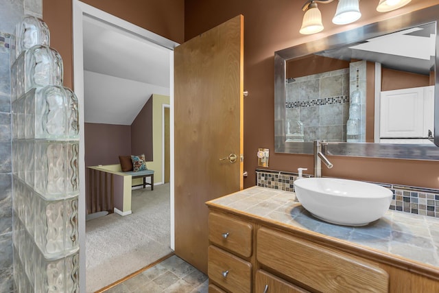 150 Hyde Rd, Clarklake, MI 49234 - bathroom with vaulted ceiling, vanity, and tasteful backsplash
