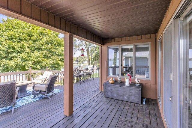 wooden deck featuring outdoor dining space