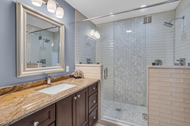 bathroom with vanity and a stall shower