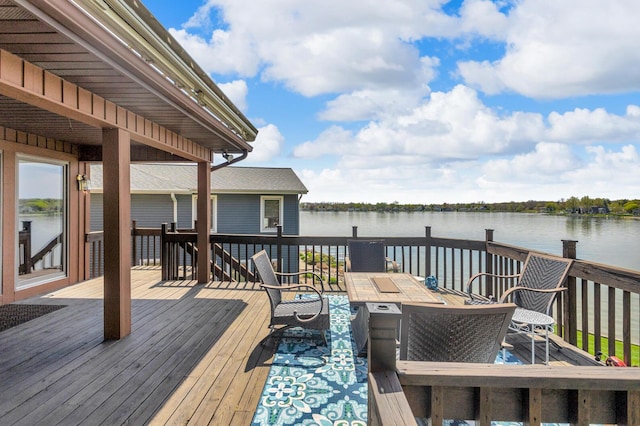 wooden deck featuring a water view and outdoor dining space
