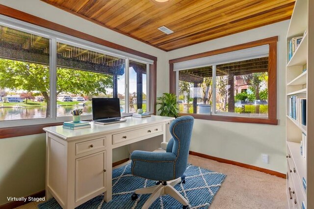 carpeted home office featuring baseboards and wooden ceiling