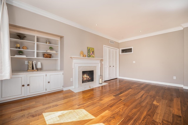 4040 Greenleaf Cir Unit 301, Kalamazoo, MI 49008 - unfurnished living room with visible vents, crown molding, wood finished floors, and a fireplace