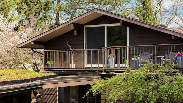 rear view of house featuring a wooden deck