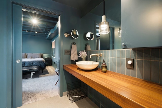 bathroom with vanity, ensuite bathroom, and backsplash