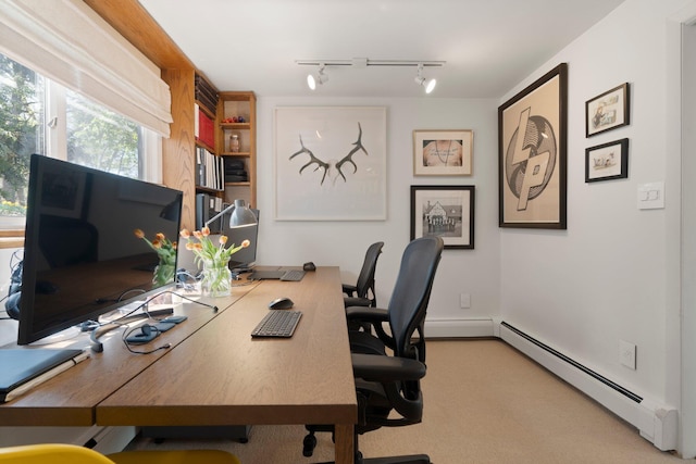 carpeted office with a baseboard heating unit and track lighting