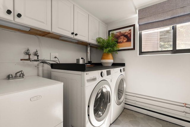 laundry room featuring light tile patterned flooring, baseboard heating, separate washer and dryer, a sink, and cabinet space