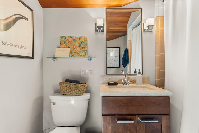 bathroom with vanity, a shower with shower curtain, and toilet