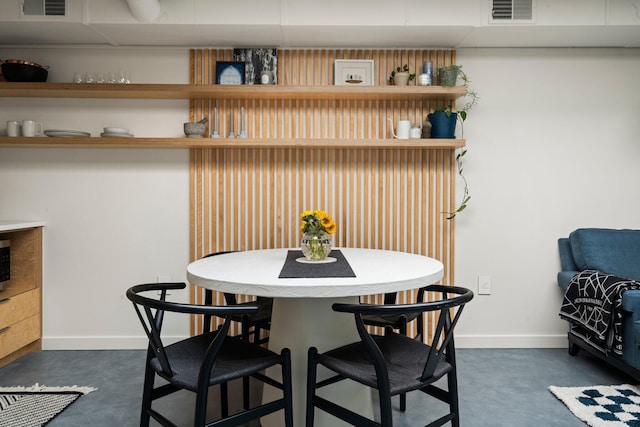 dining space with baseboards and visible vents