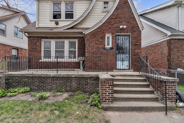 15885 Indiana St, Detroit, MI 48238 - property entrance featuring brick siding, fence, and a shingled roof