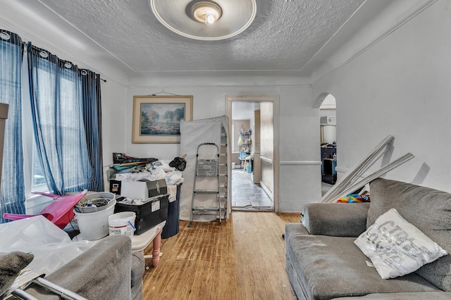 15885 Indiana St, Detroit, MI 48238 - living area with arched walkways, a textured ceiling, wood finished floors, and a wealth of natural light