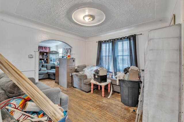 15885 Indiana St, Detroit, MI 48238 - bedroom with arched walkways, a textured ceiling, and wood finished floors
