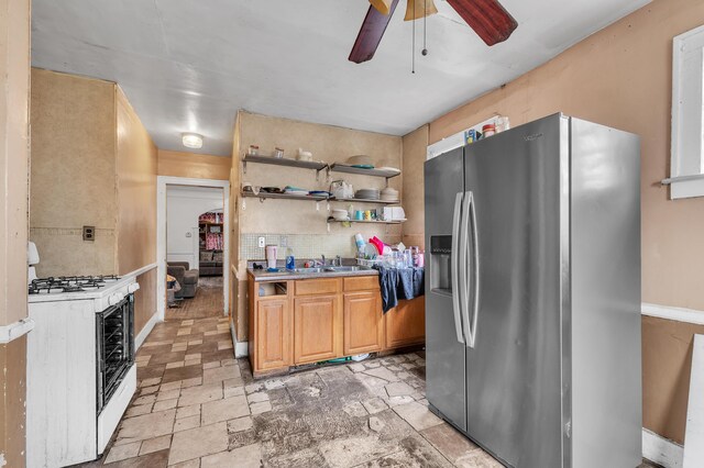 15885 Indiana St, Detroit, MI 48238 - kitchen featuring open shelves, light countertops, gas range gas stove, a ceiling fan, and stainless steel refrigerator with ice dispenser