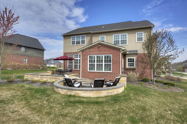 51583 Turnburry Dr, South Lyon, MI 48178 - rear view of house featuring a lawn, a patio area, and brick siding
