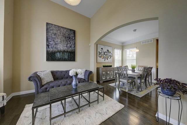 51583 Turnburry Dr, South Lyon, MI 48178 - living area with visible vents, arched walkways, wood finished floors, and a chandelier
