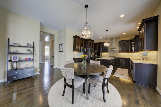 51583 Turnburry Dr, South Lyon, MI 48178 - dining area with dark wood-style flooring, a chandelier, recessed lighting, baseboards, and visible vents
